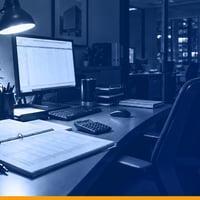 A property management desk after hours with a printed tenant ledger and a spreadsheet on screen, lit by a single lamp, under a Kardin navy gradient overlay.
