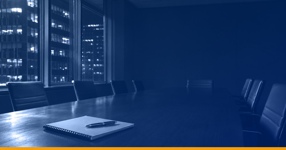 An empty boardroom at night, a notebook and pen on a long conference table, lit office towers through the windows, under a Kardin navy gradient overlay.